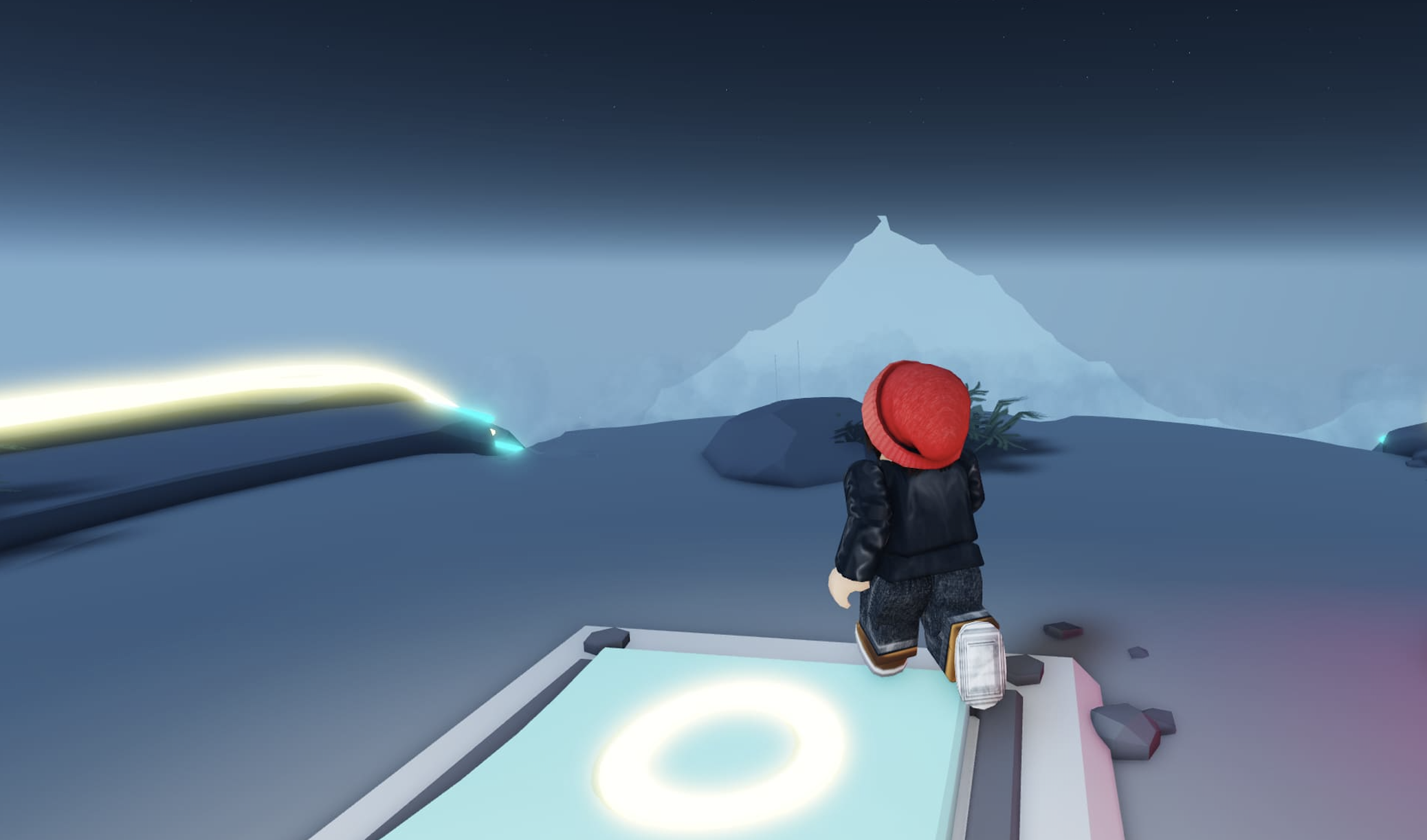 A Roblox character with a red hat stands on a platform, gazing towards a distant snowy mountain under a starry sky.